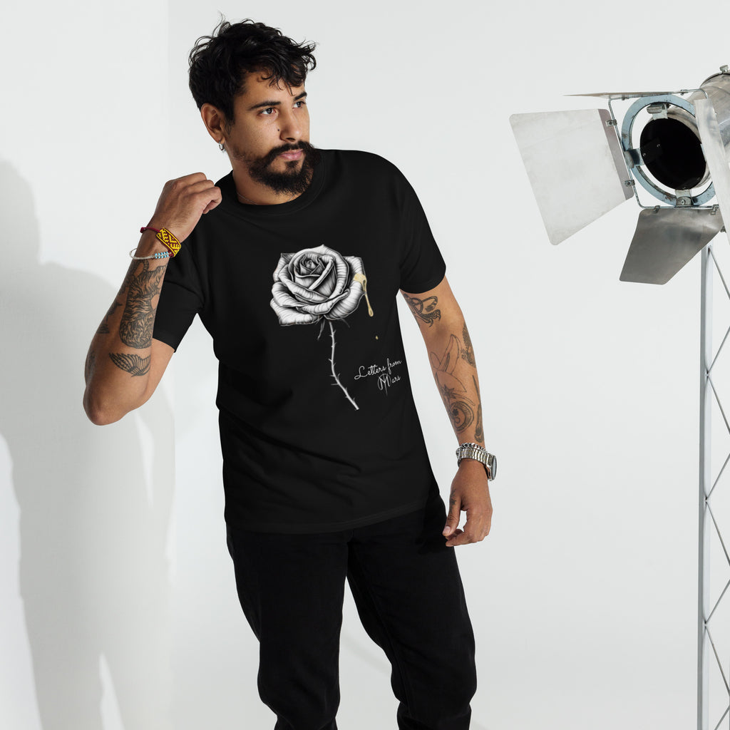 Man wearing a black t-shirt with a Letters from Mars logo and text, standing in front of studio equipment.
