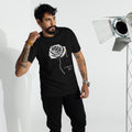 Man wearing a black t-shirt with a Letters from Mars logo and text, standing in front of studio equipment.